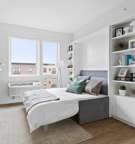 a trademark apartment living room with the murphy bed un-folded